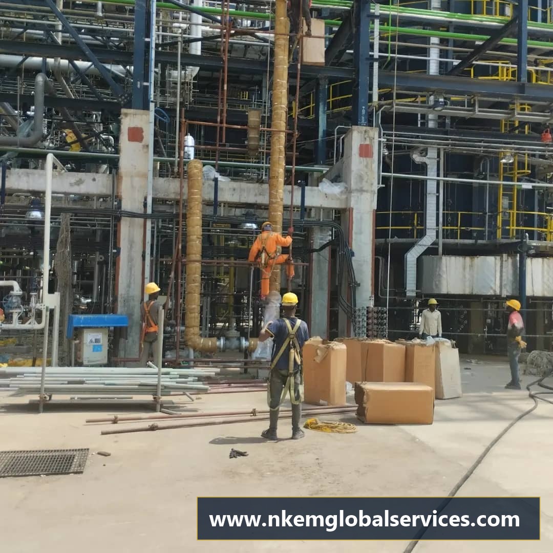 Certified multi-trade workforce installing pipeline thermal insulation with safety harnesses